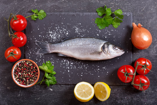 fresh fish sea bass with ingredients for cooking
