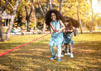 Fototapeta premium Children are happy to play tug at the park. Soft focus concept.