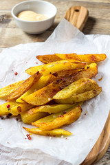 Traditional French fries on wooden cutting board