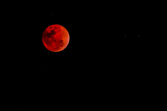 blood moon concept of a red full moon against a black sky