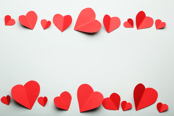 Red paper hearts on grey background