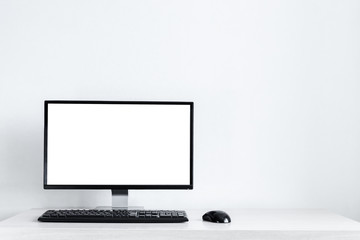 Fototapeta premium Mockup A modern desktop computer shows a blank screen on the desk