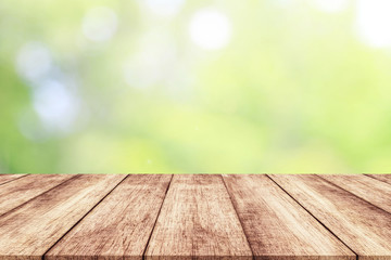 Wood table top on blur nature background with spring or summer