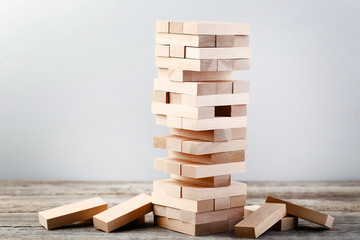 Wooden block tower game on grey table - Powered by Adobe