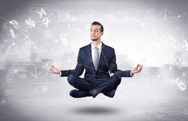 Businessman meditates with enlightenment concept