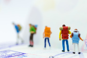 Miniature people : Backpacker group walking on passsport. Image use for travel, business concept.