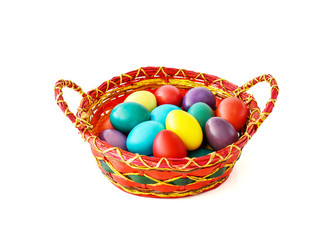Naklejka premium Colorful Easter eggs in basket on white background.