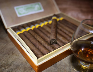 Large box of Cuban cigars on a wooden table