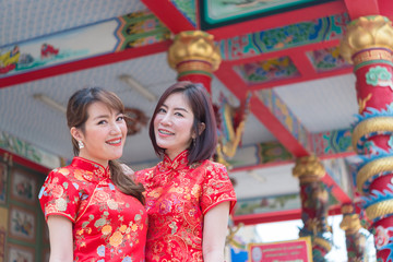Portrait two beautiful asian women in Cheongsam dress,Thailand people,Happy Chinese new year concept