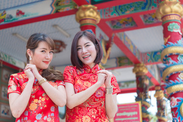 Portrait two beautiful asian women in Cheongsam dress,Thailand people,Happy Chinese new year concept