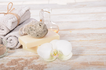 Fototapeta na wymiar gray natural soap with honey and body oil and a cosmetic face mask with place for tekst