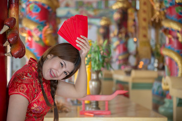 Portrait of beautiful asian woman in Cheongsam dress,Thailand people,Happy Chinese new year concept