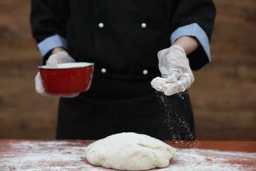 the cook makes flour for baking on the table