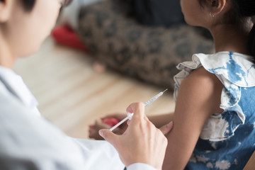 Close up of doctor vaccinating young girl, Vaccination concept. - obrazy, fototapety, plakaty