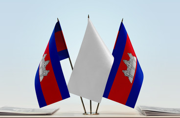 Two flags of Cambodia with a white flag in the middle