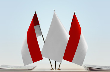 Two flags of Indonesia with a white flag in the middle