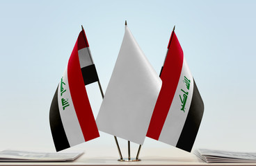Two flags of Iraq with a white flag in the middle
