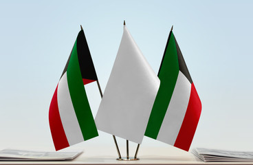 Two flags of Kuwait with a white flag in the middle
