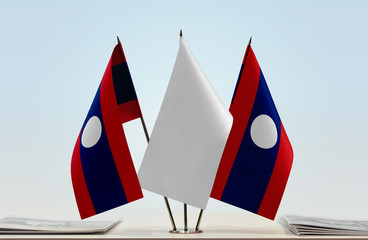 Two flags of Laos with a white flag in the middle