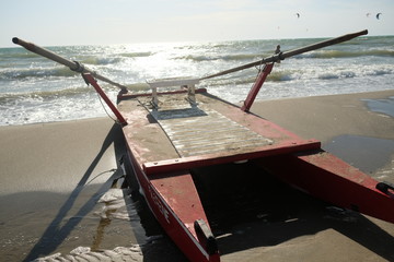 Italian paddle boat for the rescue (Italian: salvataggio) moored on the beach