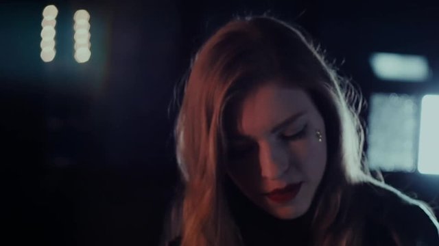 Attractive girl singing near the mirror. Portrait woman closeup. Steadicam