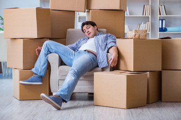 Young man moving in to new house with boxes