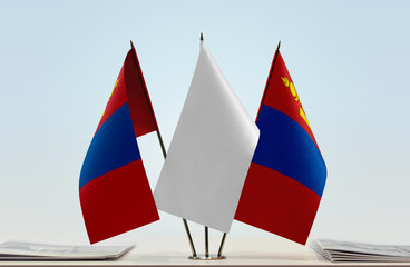 Two flags of Mongolia with a white flag in the middle