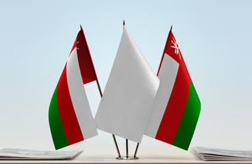 Two flags of Oman with a white flag in the middle