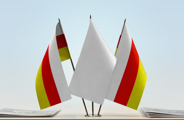 Two flags of South Ossetia with a white flag in the middle