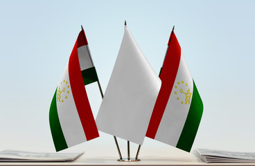 Two flags of Tajikistan with a white flag in the middle