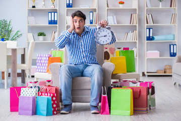 Young man after excessive shopping at home