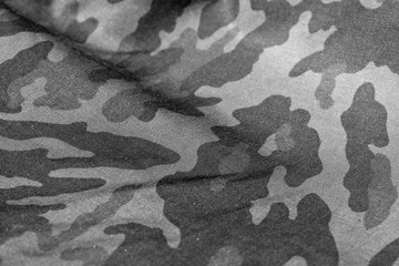 Military uniform pattern with blur effect in black and white.