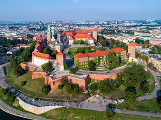 Fototapeta na wymiar Poland. Skyline panorama of Krakow old city with Wawel Hill, Cathedral, Royal Wawel Castle, fortified walls, park, promenade and unrecognizable walking people.
