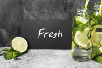 Detox drink with cucumber, lemon and mint on a gray background