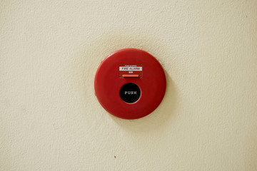 Red Fire Alarm on an Old White Painted Concrete Wall