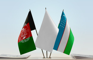 Flags of Afghanistan and Uzbekistan with a white flag in the middle