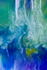 Colorful inks dissolving in water in a swirl