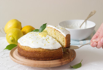 Lemon cake with whipped cream on a light background.