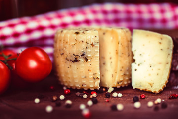 Rustic cheese with herbs, pepper and tomatoes