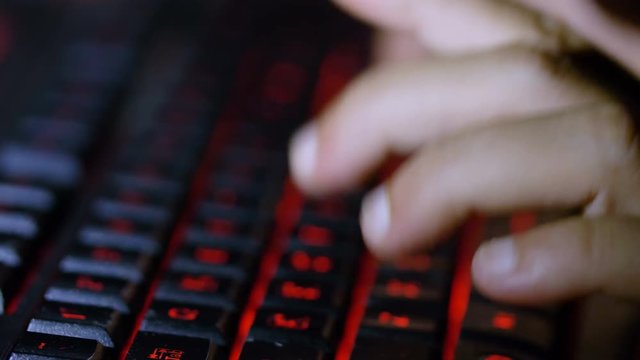 close up on woman hands typing on lightning keyboard