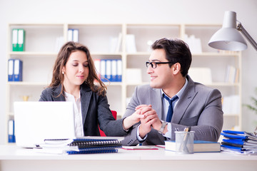 Happy couple working in the same office