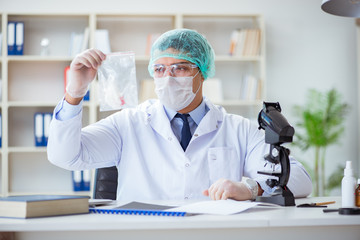 Forensics investigator working in lab on crime evidence