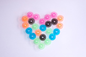 hearts from sewing colorful bobbins on white phonetics. Valentine's Day greeting card,