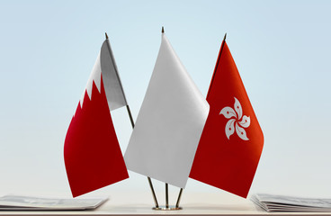 Flags of Bahrain and Hong Kong with a white flag in the middle