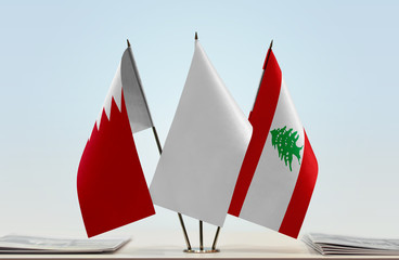 Flags of Bahrain and Lebanon with a white flag in the middle