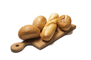 Baguette homemade and round crispy bun on a wooden board isolated on white