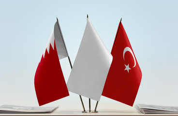 Flags of Bahrain and Turkey with a white flag in the middle