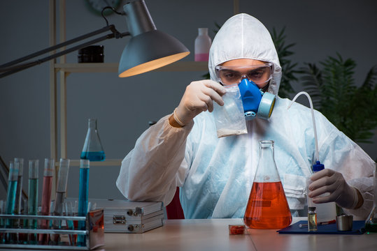 Young make scientist working with dangerous hazardous substances