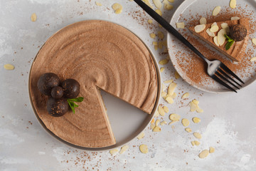 Raw vegan chocolate-caramel cheesecake with raw balls. Healthy vegan food concept. Top view