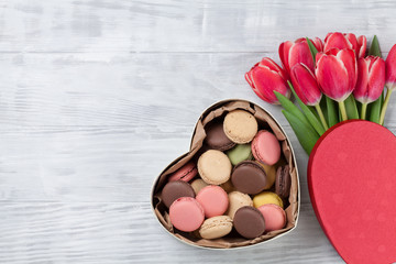 Red tulip flowers and macaroons